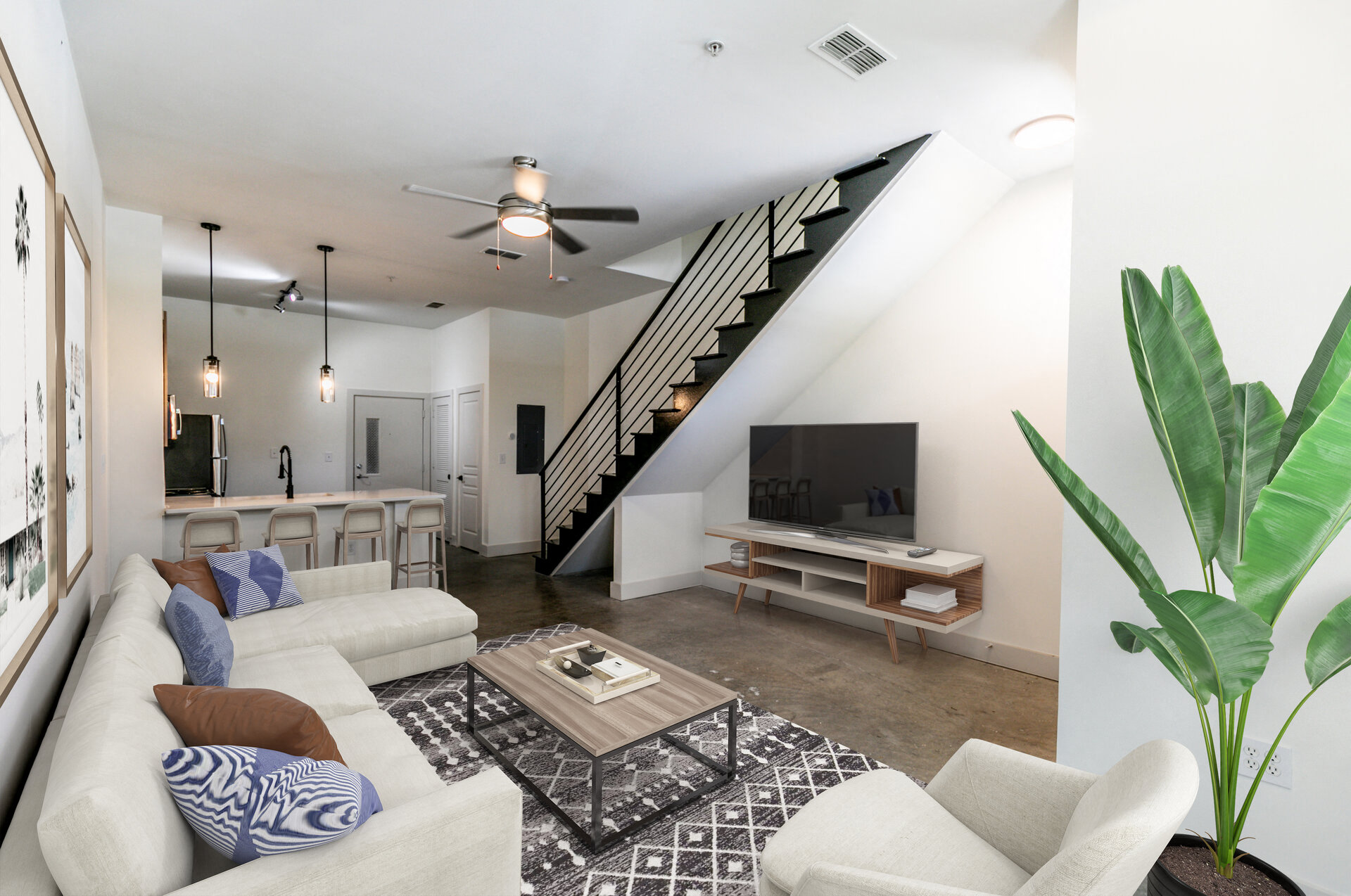 a living room with a white couch and a television